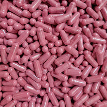 A close-up pile of pink translucent capsules containing organic beetroot powder,  filling the entire frame. 
