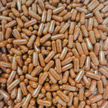 A close-up, top-down view of numerous certified organic cayenne pepper capsules packed tightly together.